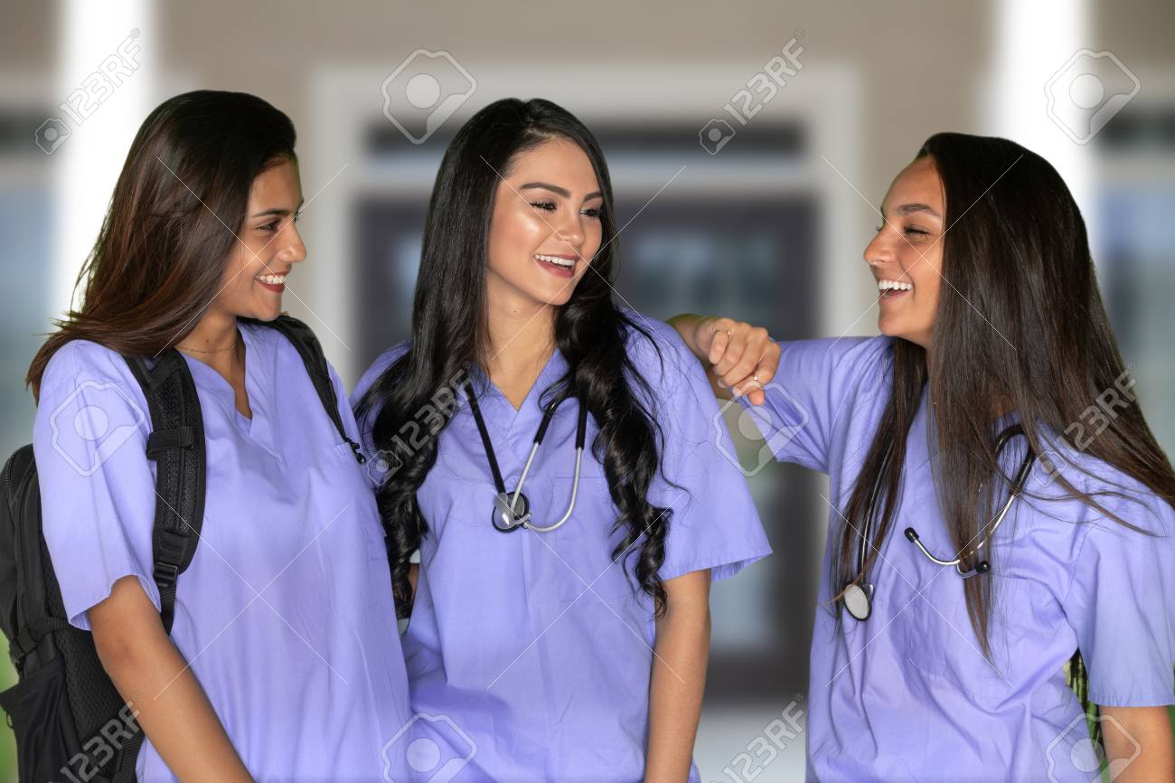 Three happy hispanic nursing students at school - 115211592 Three happy hispanic nursing students at school - 115211592