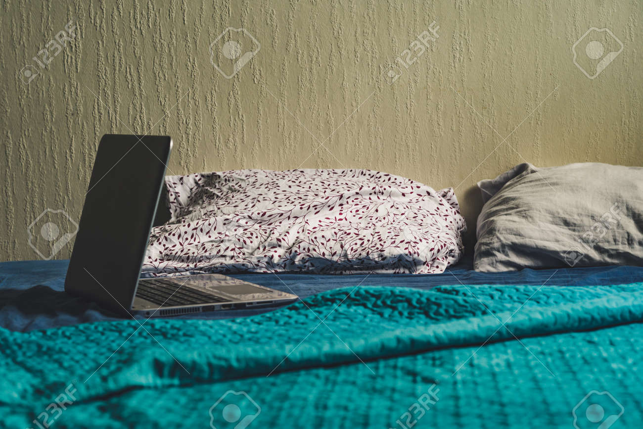 Grey Laptot Laying On Mattress With Turquoise Cover Few Pillows Stock Photo Picture And Royalty Free Image Image 109070353