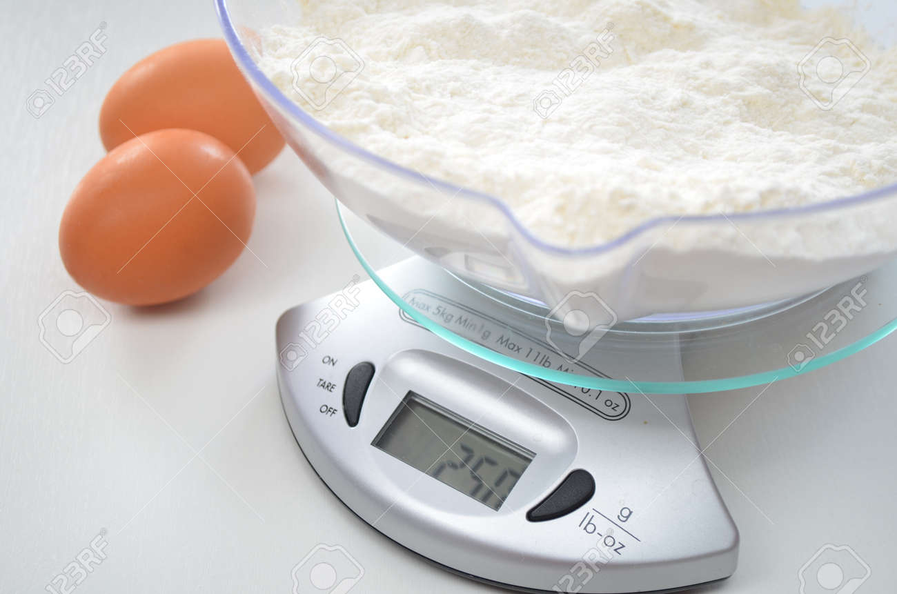 eggs and flour on a weighing scale stock photo picture and royalty