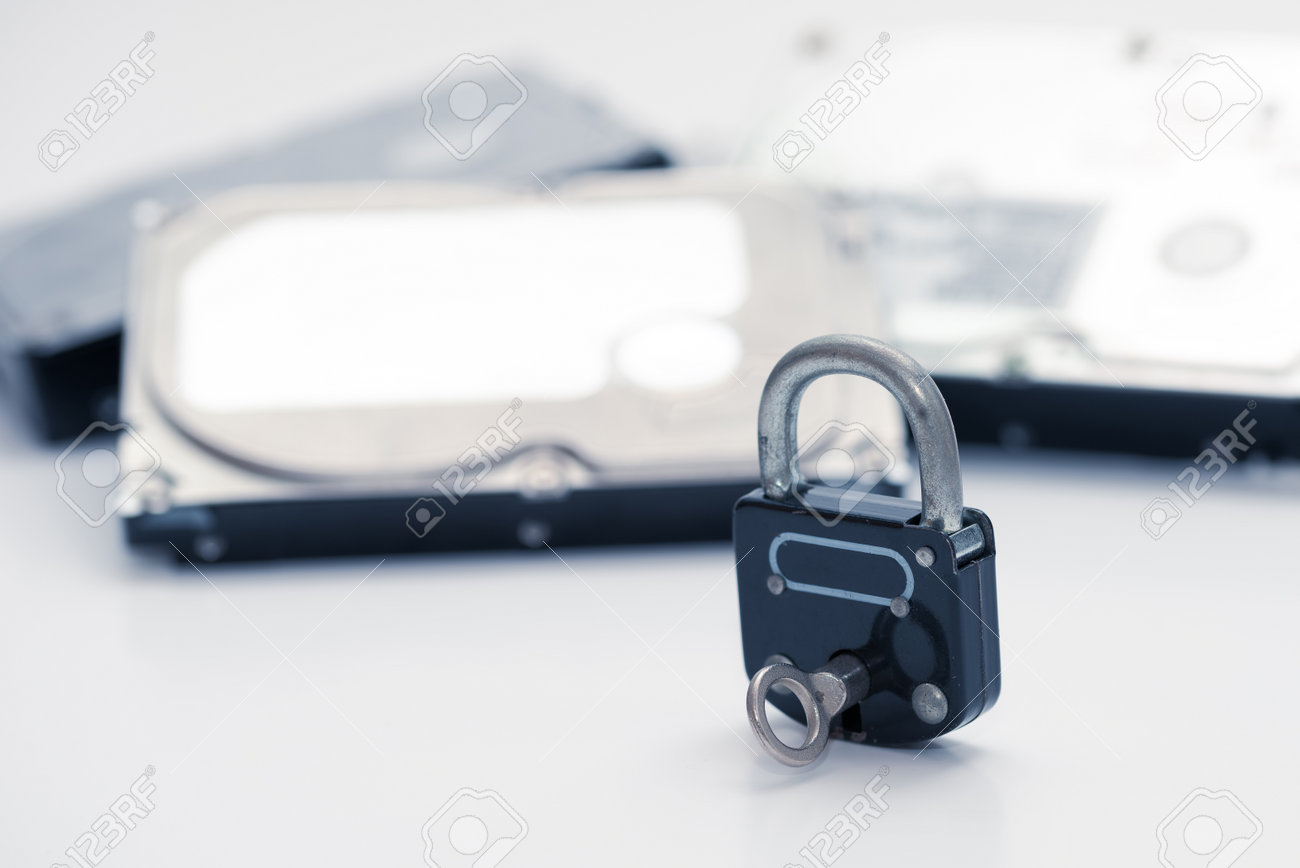 Computer hard disks and metal padlock with key symbolizing concept for encrypted data, cyber security - 162314755 Computer hard disks and metal padlock with key symbolizing concept for encrypted data, cyber security - 162314755