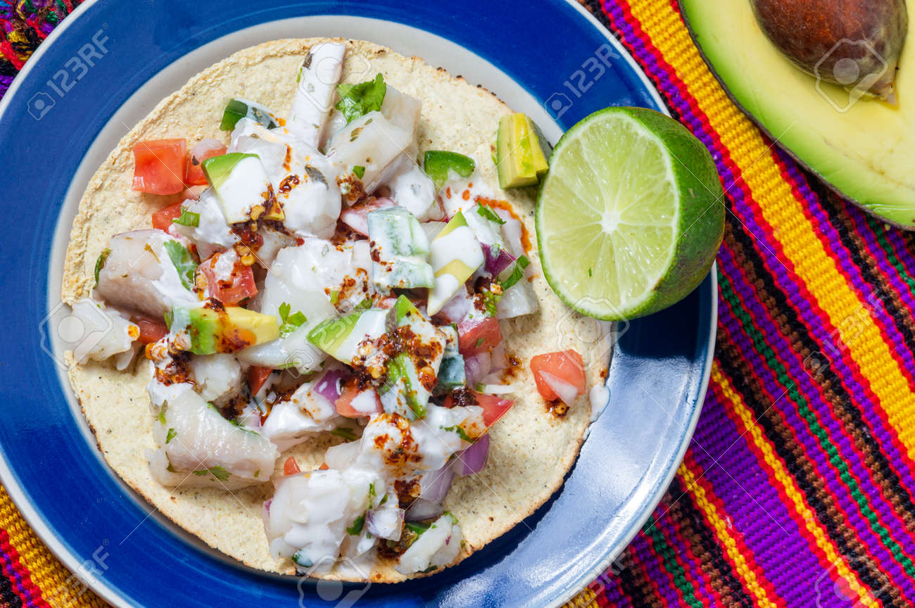 Fish Ceviche Mexican Food From Peruvian Origin Raw Fish Marinated In Lime Juice With Raw Onion Tomato Jalapeno Pepper Avocado And Herbs Served On Crispy Fried Tortillas Stock Photo Picture And Royalty