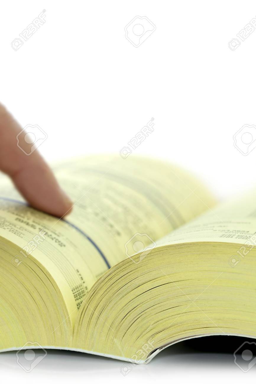 yellow pages telephone directory with a finger finding a listing