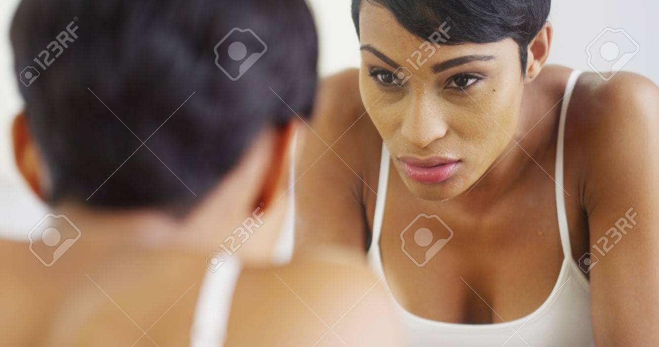 黒人女性の顔に水をはねかけると鏡で見ています の写真素材 画像素材 Image
