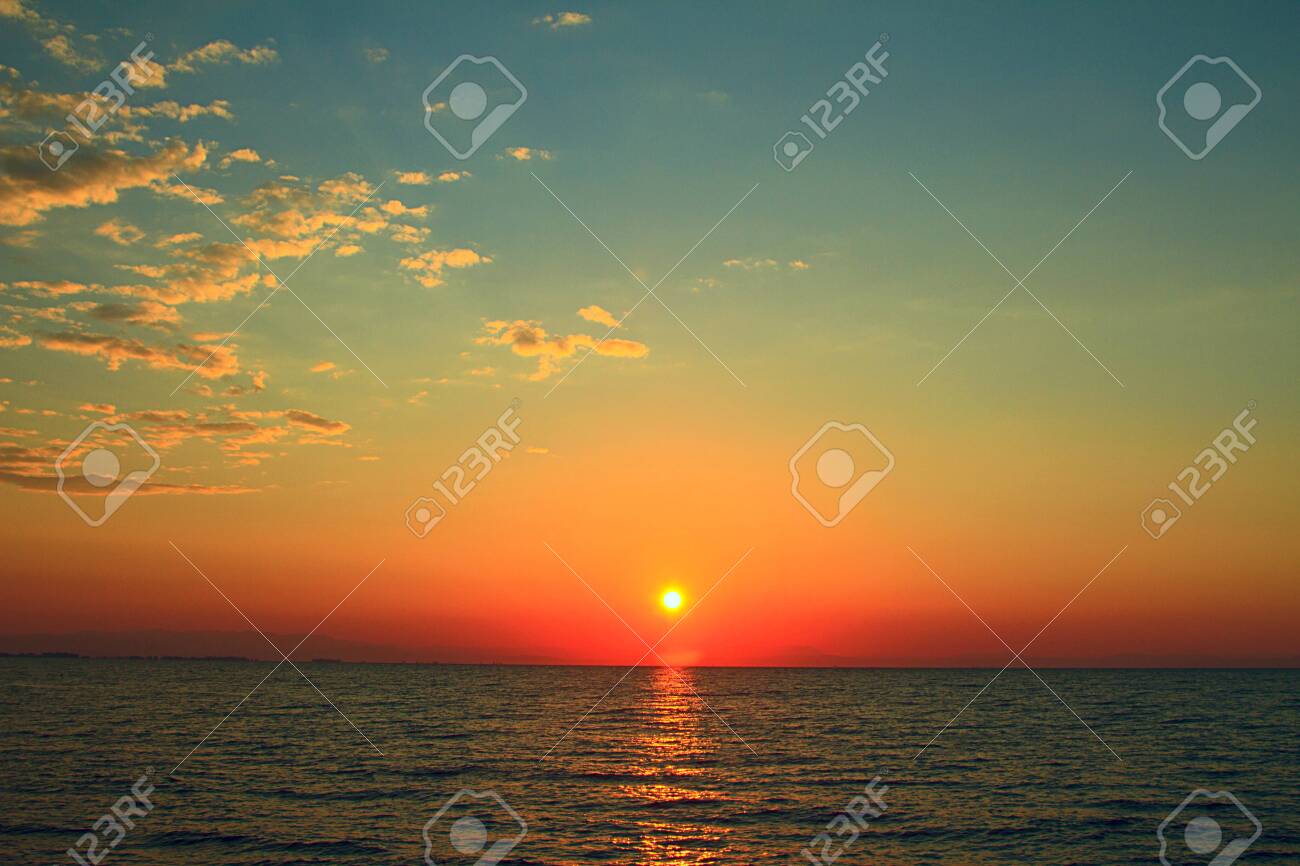 Bright sunset with yellow sun under the sea surface - 120504979 Bright sunset with yellow sun under the sea surface - 120504979