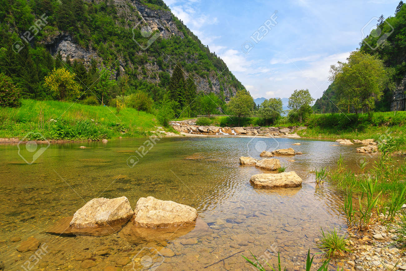 Stream with its refreshing water between the mountain peaks - 166782530 Stream with its refreshing water between the mountain peaks - 166782530