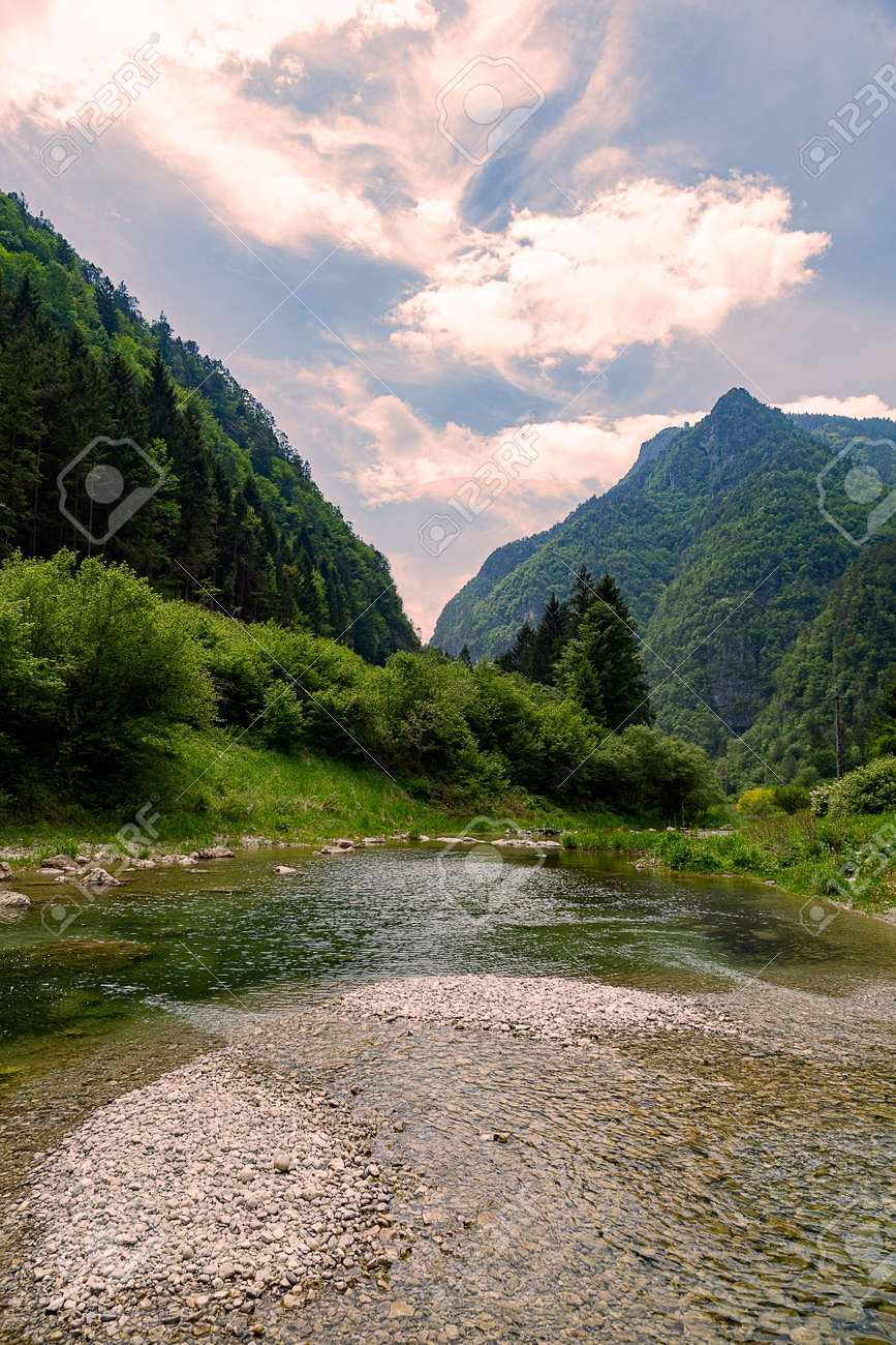 Stream with its refreshing water between the mountain peaks - 166782932 Stream with its refreshing water between the mountain peaks - 166782932