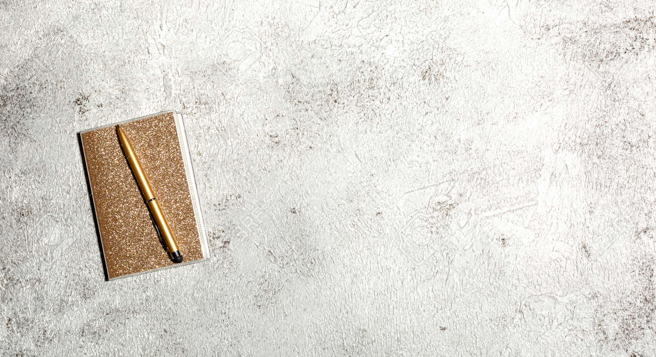 Notebook and pen on a gray concrete background. Female workspace. Top view, flat lay, copy space - 166783129 Notebook and pen on a gray concrete background. Female workspace. Top view, flat lay, copy space - 166783129