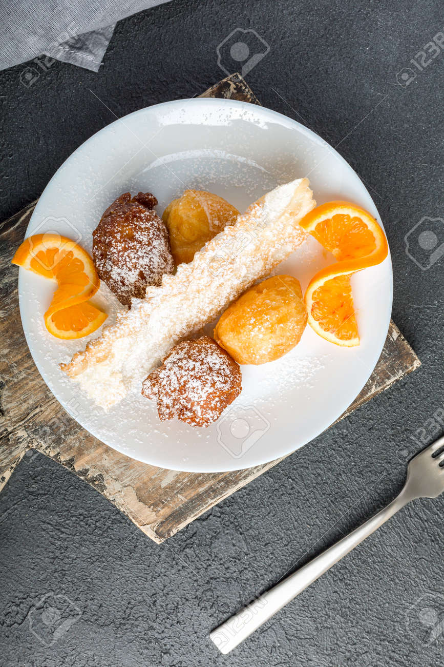 Carnival dessert on plate isolated on black background - 167193624 Carnival dessert on plate isolated on black background - 167193624