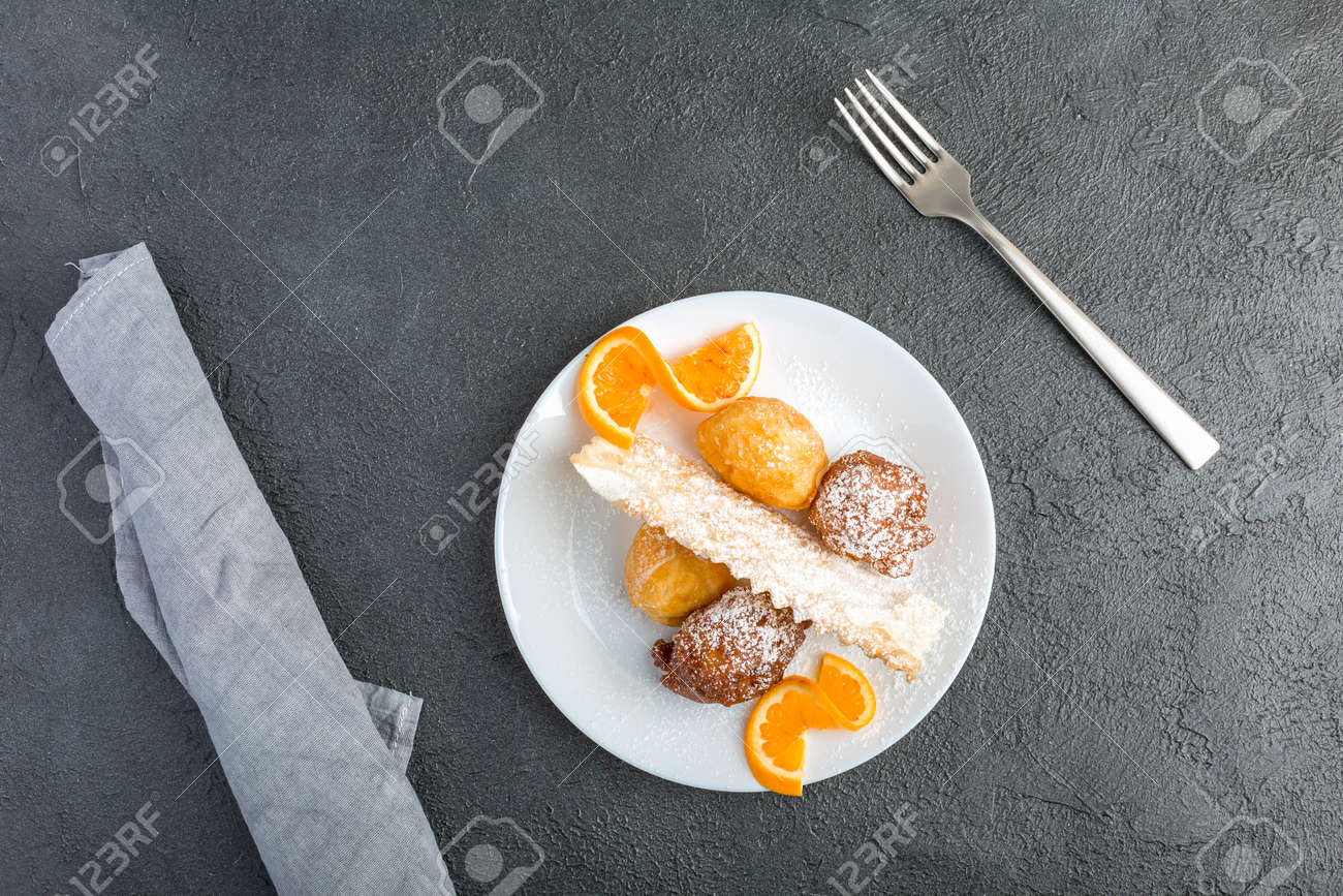 Carnival dessert on plate isolated on black background - 167780025 Carnival dessert on plate isolated on black background - 167780025