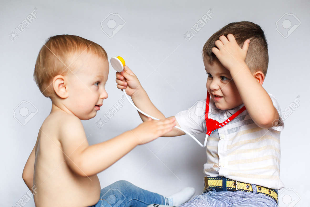 children playing doctor and patient two little boys using stethoscope children play doctor