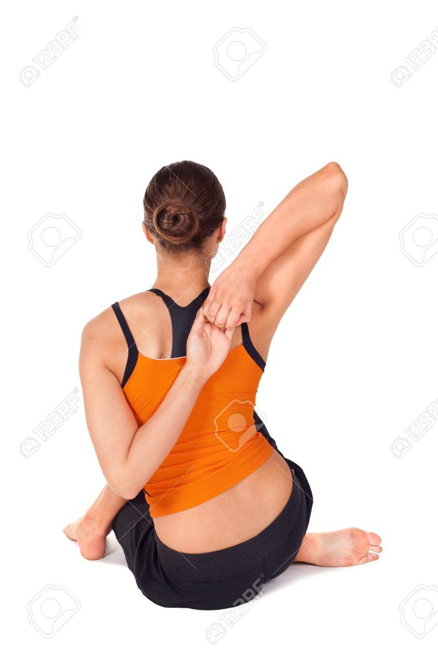Woman doing yoga exercise called Cow Face Pose, sanskrit name:.. Woman doing yoga exercise called Cow Face Pose, sanskrit name:..