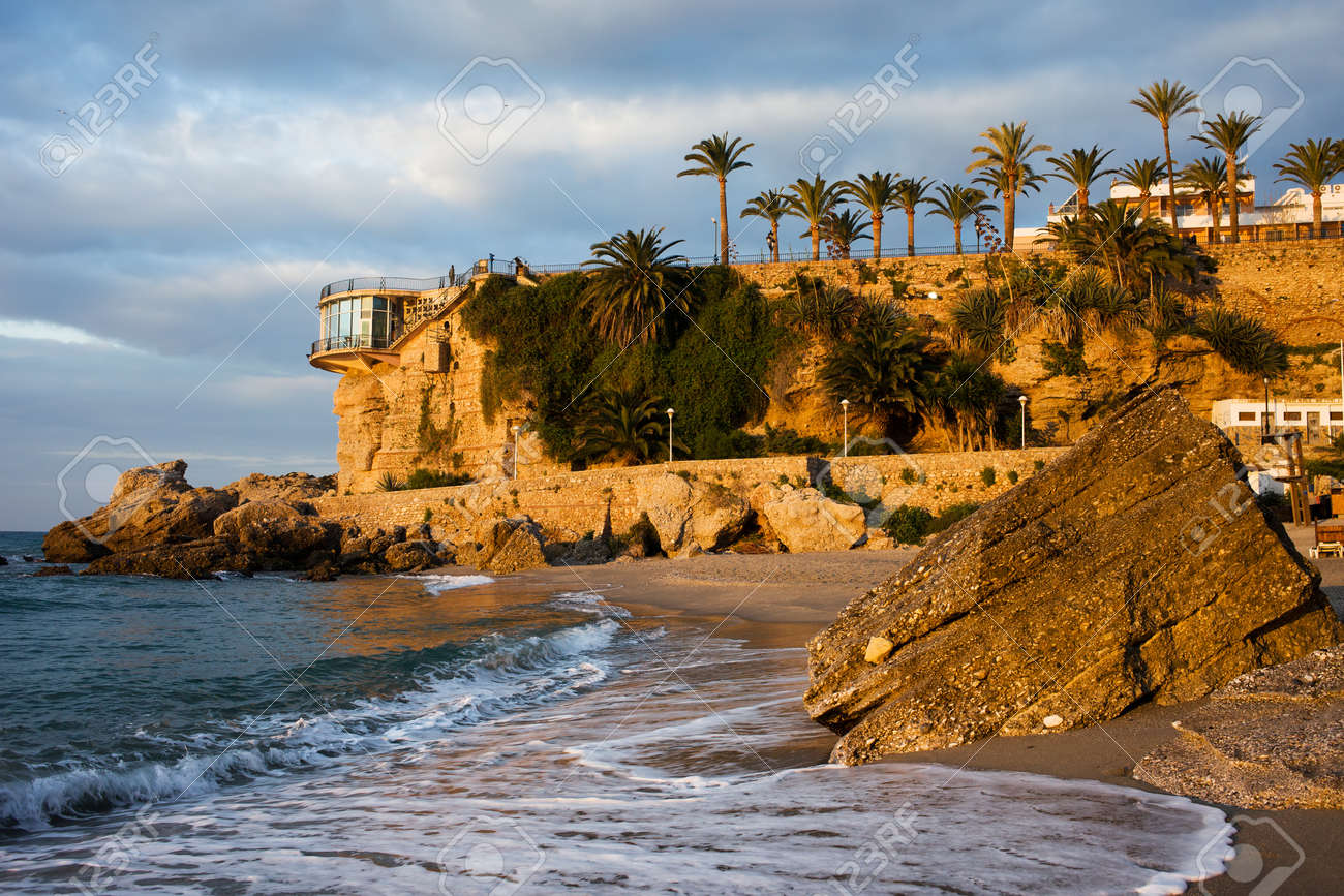 Sunrise on the picturesque coastline of the Mediterranean Sea and Balcon de Europa famous vantage point in resort town of Nerja, Costa del Sol, Spain. - 13713336 Sunrise on the picturesque coastline of the Mediterranean Sea and Balcon de Europa famous vantage point in resort town of Nerja, Costa del Sol, Spain. - 13713336