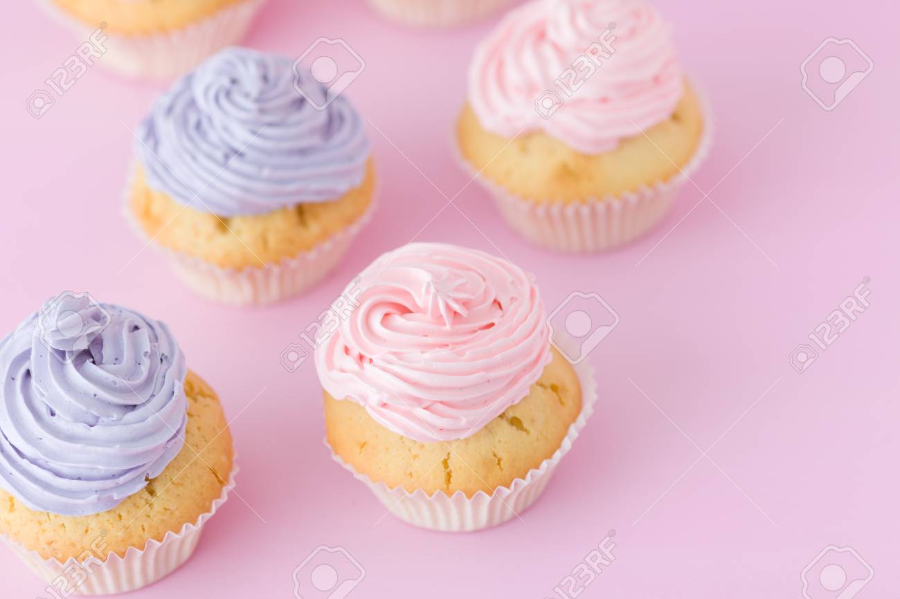 Violet And Pink Cupcakes With Buttercream Standing On Pastel