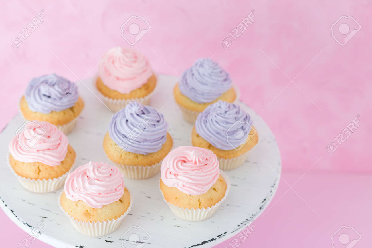Cupcakes With Pink And Violet Buttercream Standing On Pastel