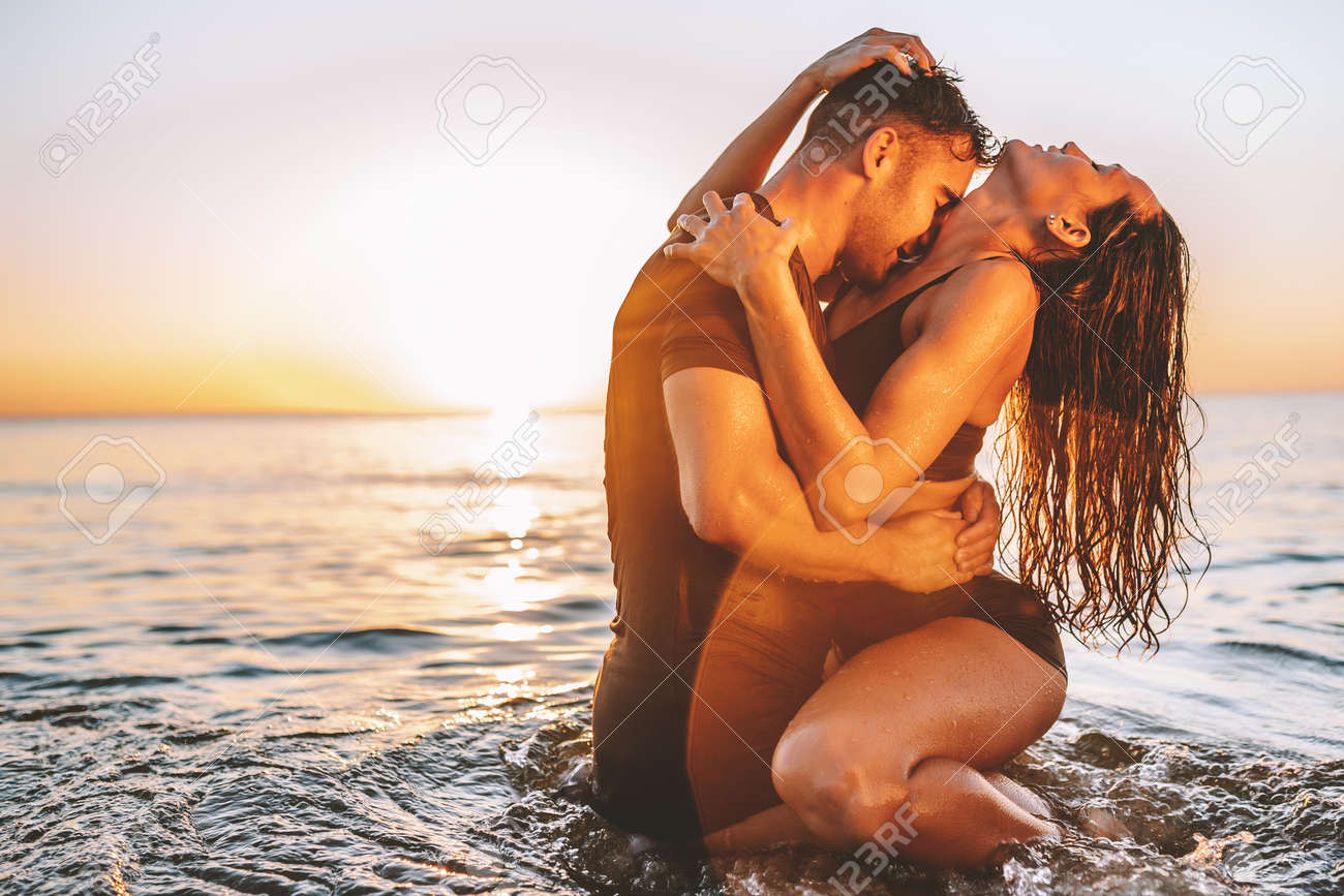 Happy Young Fit Couple Embrace Each Other With Love In The Sea Or Ocean At  Summer Sunset. Romantic Mood, Tenderness, Relationship, Vacation Concept.  Stock Photo, Picture and Royalty Free Image. Image 165795499., image size:1300x867
