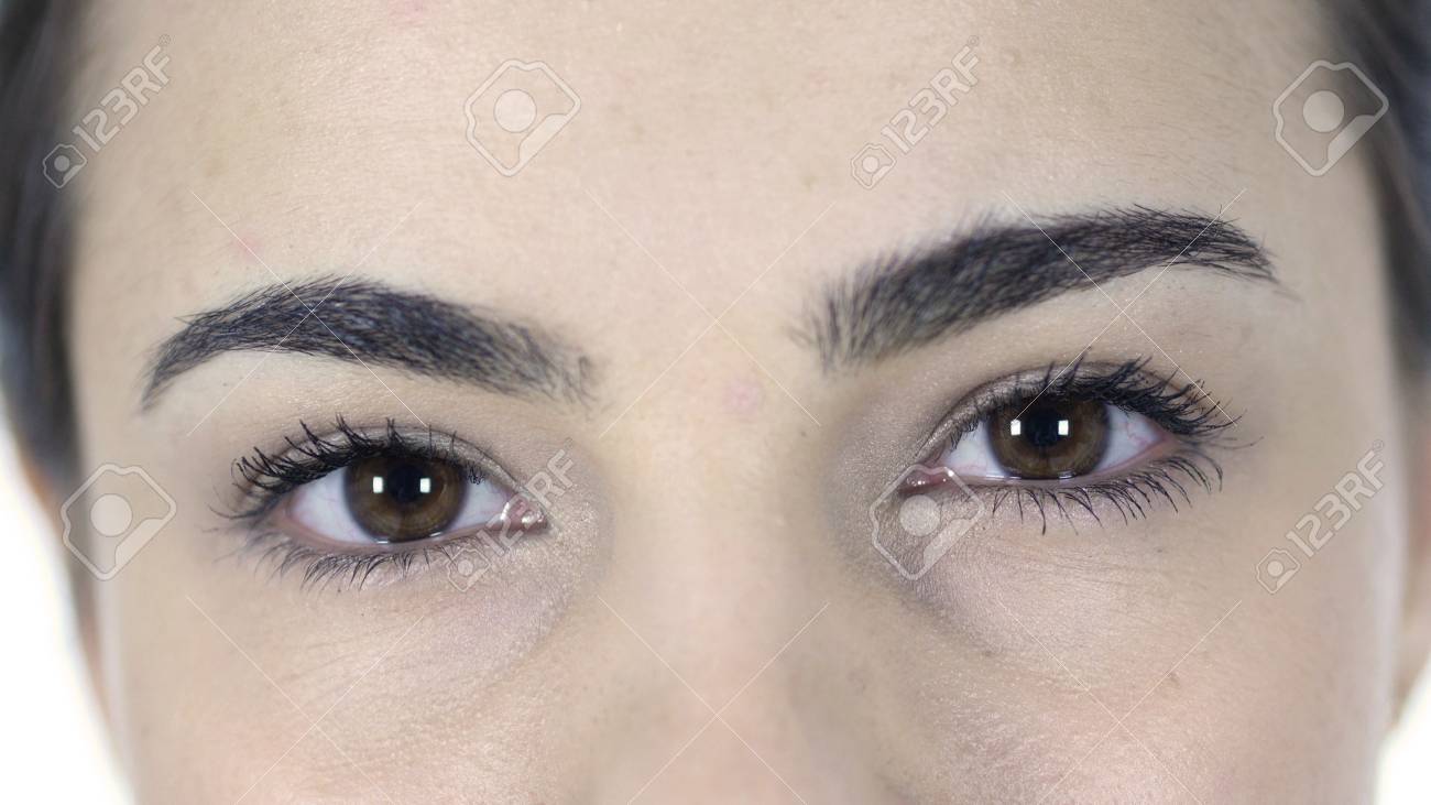 blinking eyes of woman isolated on white background stock photo