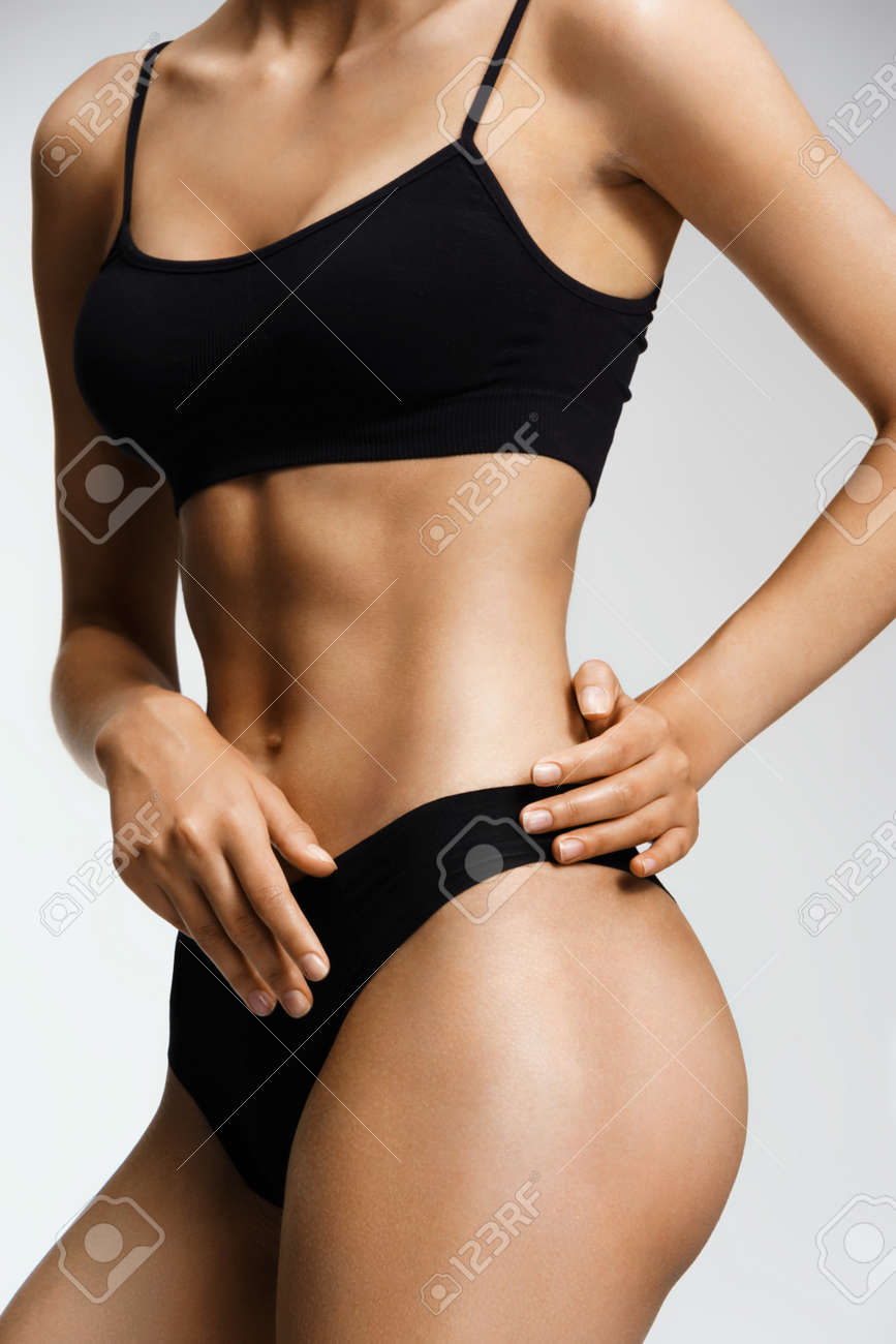 Sporty Woman In Black Lingerie Cares About Her Body. Perfect Slim Toned  Young Body Of The Girl. Fitness Or Body Care Concept Stock Photo, Picture  and Royalty Free Image. Image 75617882.