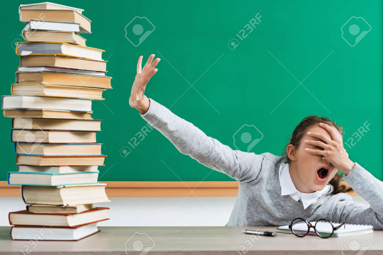 Shocked student closes her eyes to a lot of books. Portrait of young girl with shocked facial expression in school. Back to school! - 82926881 Shocked student closes her eyes to a lot of books. Portrait of young girl with shocked facial expression in school. Back to school! - 82926881