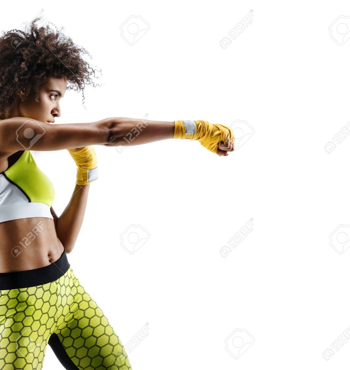 Boxer woman in yellow bandages making direct hit. Photo of sporty african woman during boxing on white background. Dynamic movement. Side view - 91841152 Boxer woman in yellow bandages making direct hit. Photo of sporty african woman during boxing on white background. Dynamic movement. Side view - 91841152