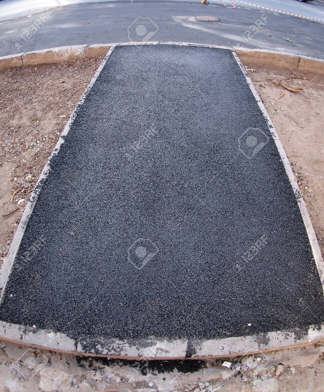 the fresh black just laid asphalt at the road with wide angle laid asphalt