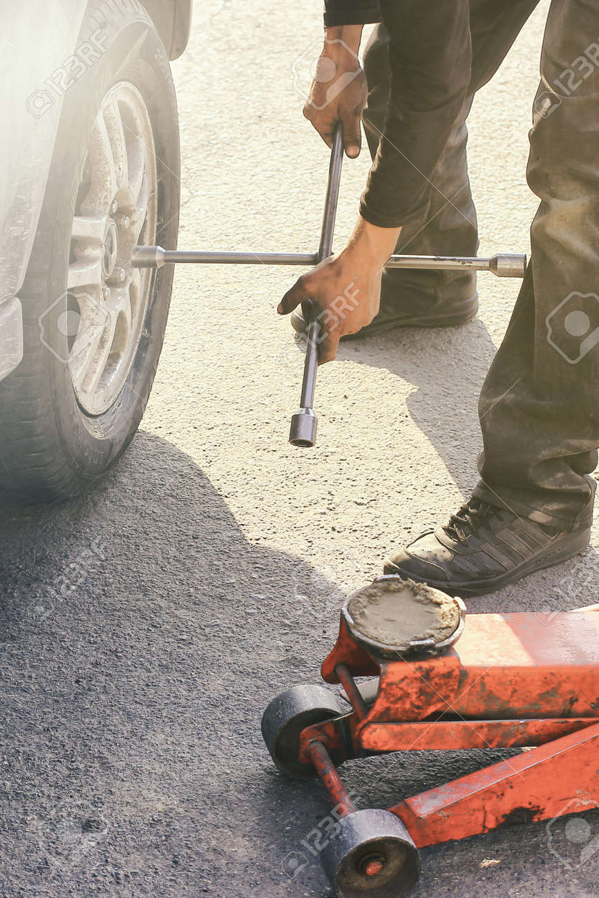 Wheel Repair Life Style Scene Whith Red Hydraulic Floor Jack Stock
