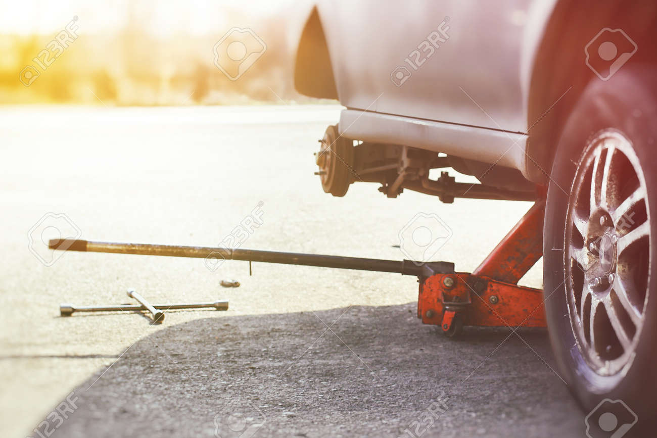 A Hydraulic Floor Jack And Wheel Wrench Ready For Wheel Repair