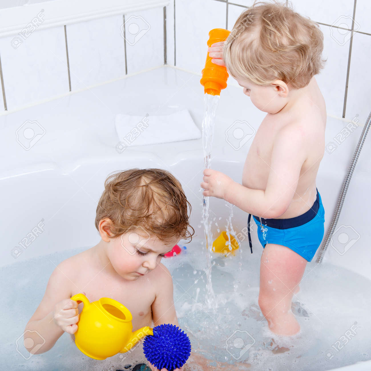 自宅のバスタブでお風呂を取って水で楽しく 2 人の小さな面白い兄弟男の子 子供は遊んでおもちゃと一緒に協力して 掃除 洗濯 ヘルスケアの概念は子供 の写真素材 画像素材 Image