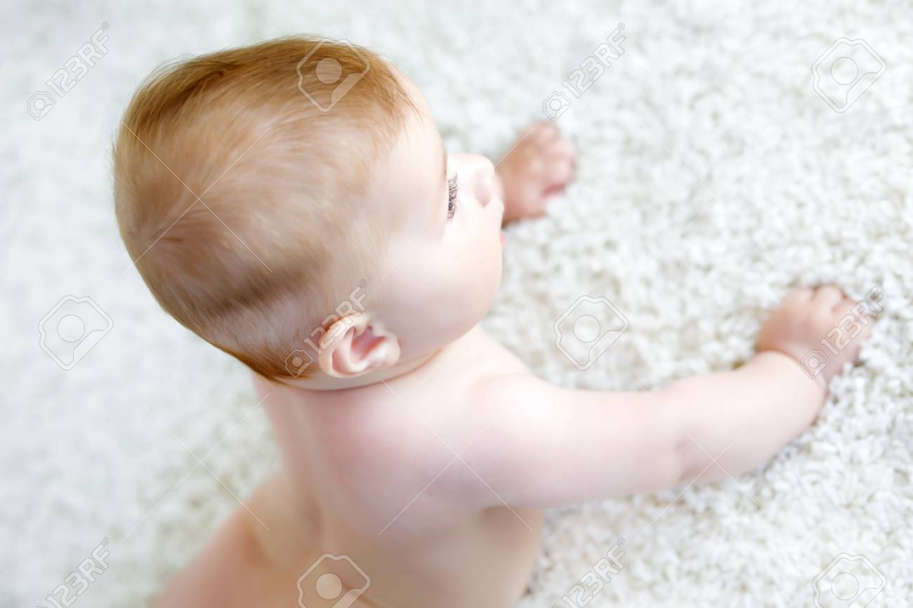 Portrait Of Cute Baby Girl Learning Crawling New Born Child