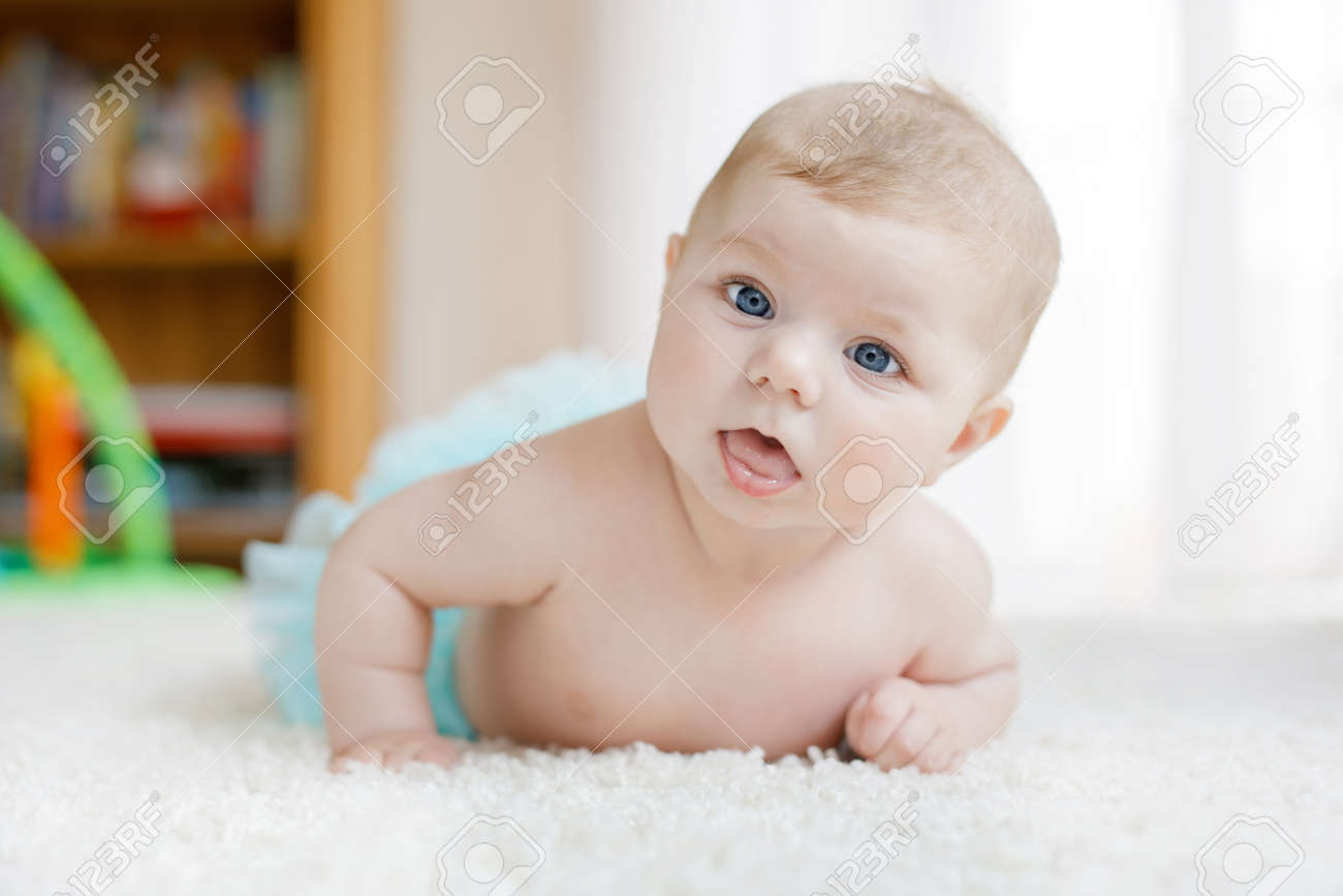 Adorable baby girl on white background wearing turquoise tutu skirt. Cute little child laughing and smiling. Happy carefree baby. Childhood, new life concept - 121029623 Adorable baby girl on white background wearing turquoise tutu skirt. Cute little child laughing and smiling. Happy carefree baby. Childhood, new life concept - 121029623