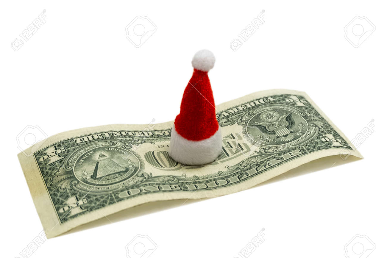 アメリカの新年のお祝いはいくらですか。クリスマスのための財政コストの概念。1ドル紙幣の中央に赤いサンタクロースのお土産の帽子。分離。の写真素材・画像素材  Image 112615470