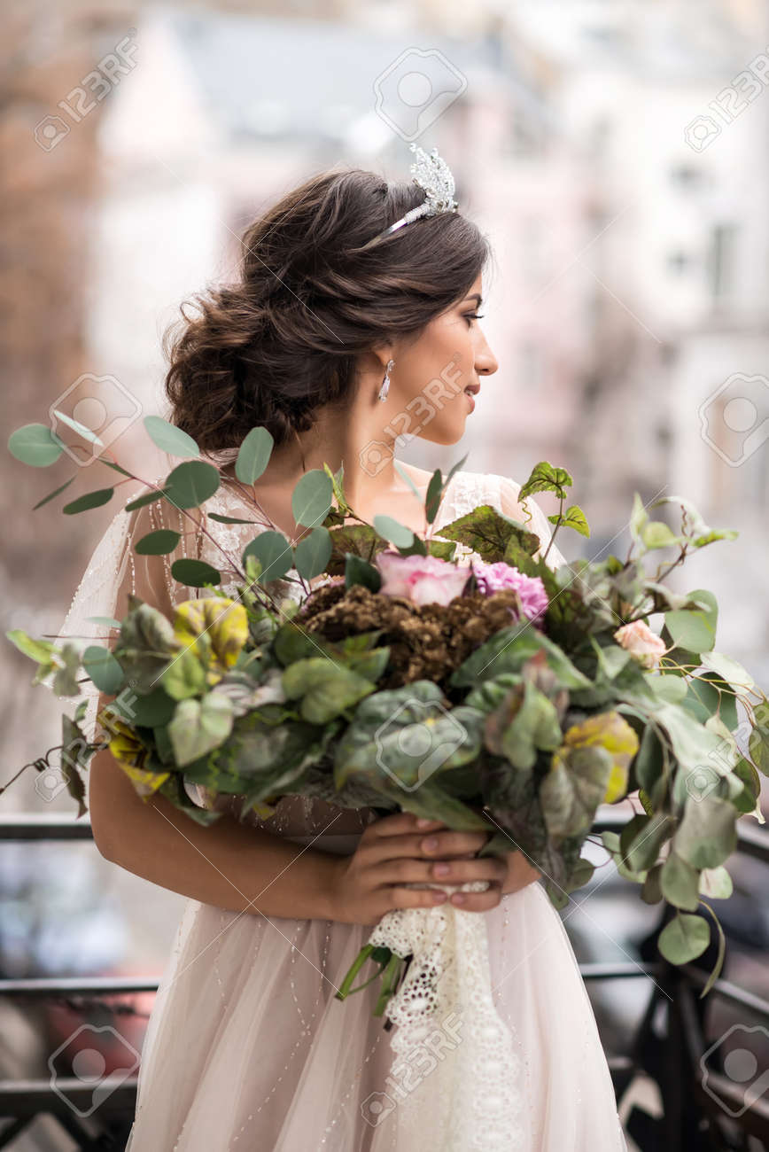 bride with a bouquet of flowers on the balcony - 70804679 bride with a bouquet of flowers on the balcony - 70804679