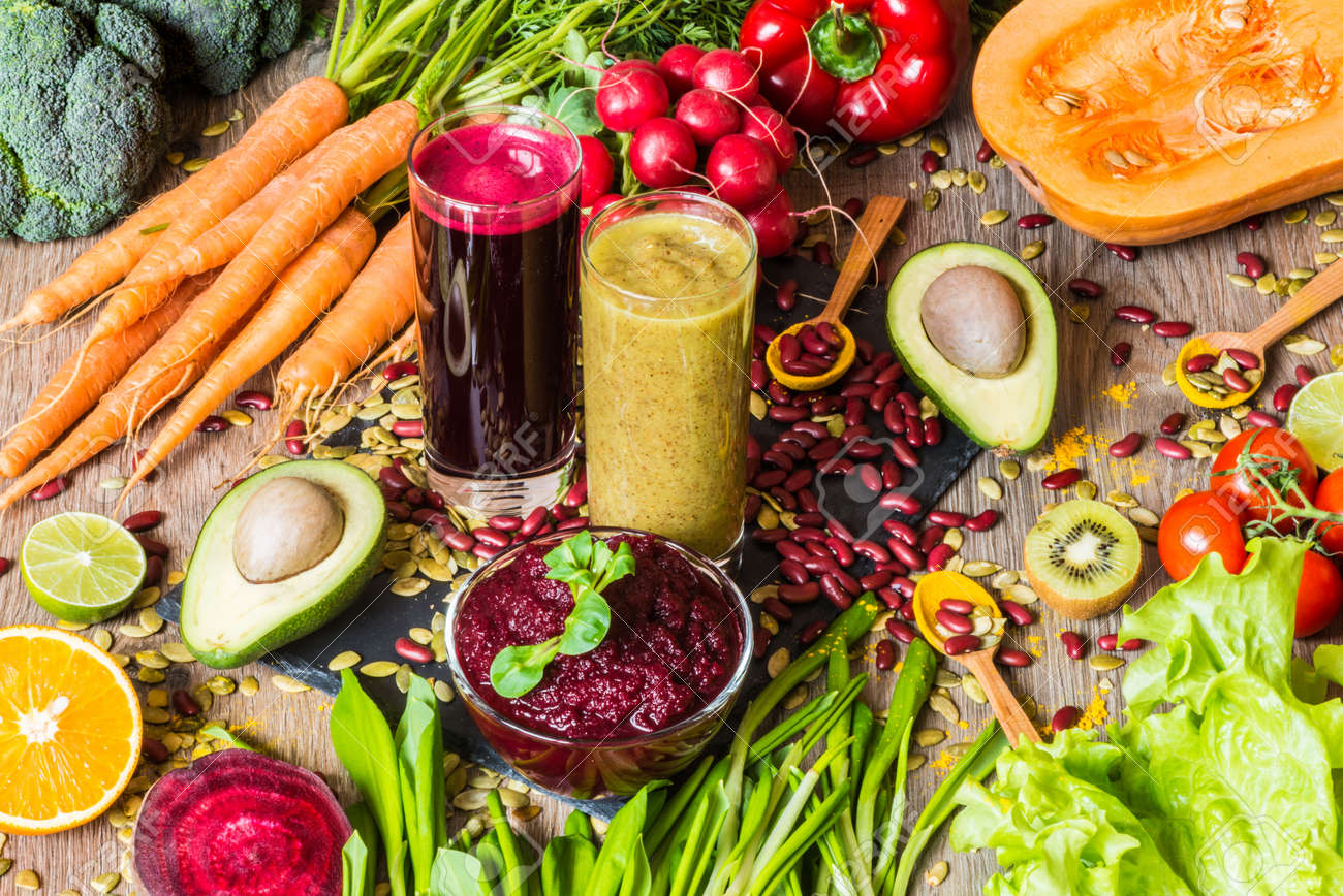 Healthy vegan food. Fresh vegetables on wooden background. Detox diet. Different colorful fresh juices - 75459808 Healthy vegan food. Fresh vegetables on wooden background. Detox diet. Different colorful fresh juices - 75459808