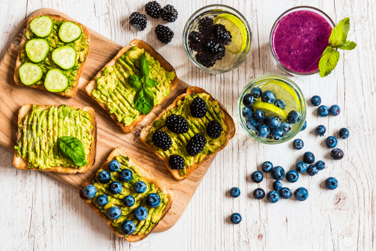 Set of vegetarian toast sandwiches with avocado and drinks. Variety of healthy food and drinks on white wooden background - 82330702 Set of vegetarian toast sandwiches with avocado and drinks. Variety of healthy food and drinks on white wooden background - 82330702