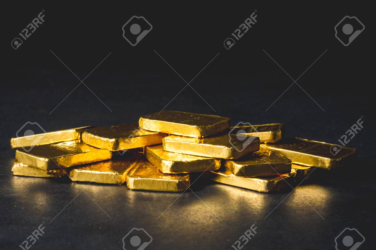 Stack of Pure gold bars on black background - 99660256 Stack of Pure gold bars on black background - 99660256