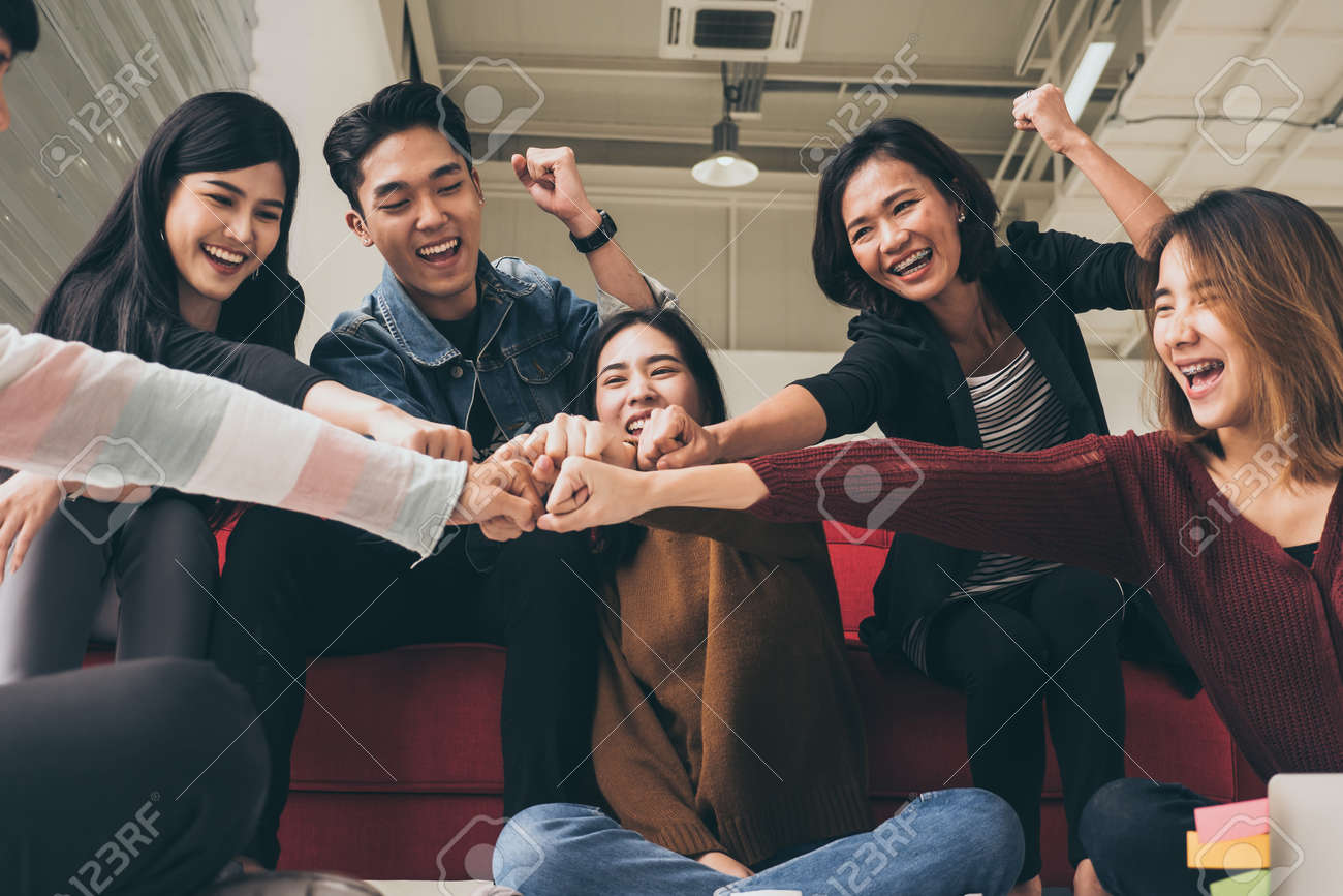 Young successful businesspeople are fist bumping after working hard at new project - 109816689 Young successful businesspeople are fist bumping after working hard at new project - 109816689