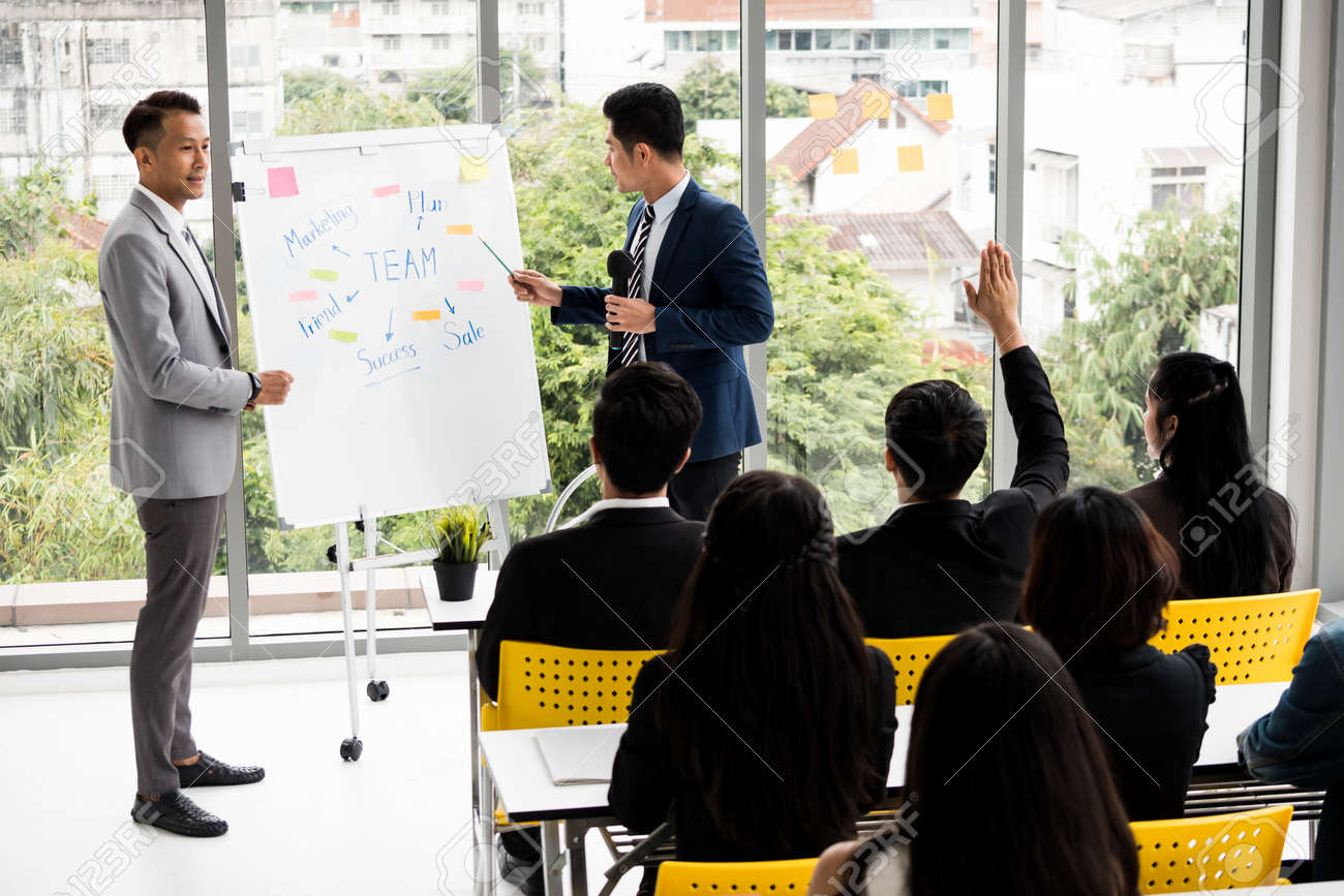Businessman is explaining works to officers while training together at the office. - 117831419 Businessman is explaining works to officers while training together at the office. - 117831419