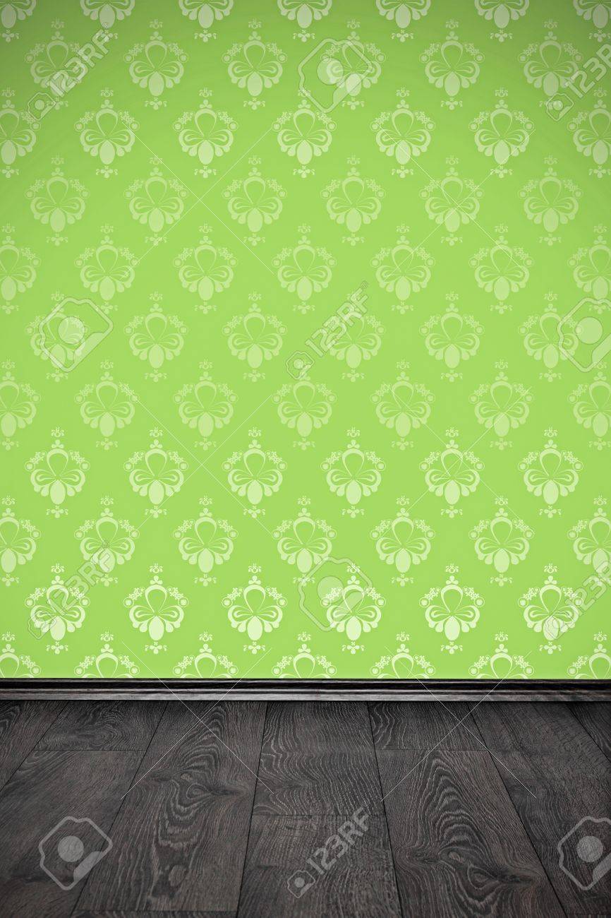 blank wall with green floral wallpaper and wooden floor stock