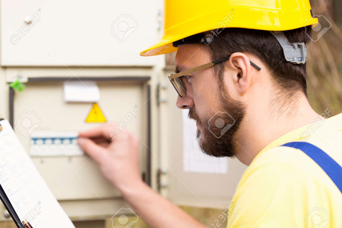 electrician checking fuse box Stock Photo - 57525689
