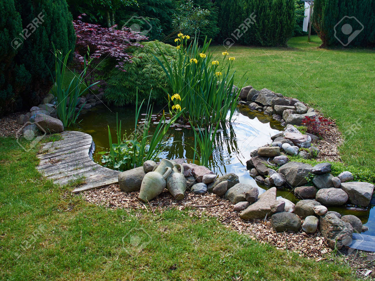 Beautiful classical garden fish pond surrounded by grass gardening background - 58920800 Beautiful classical garden fish pond surrounded by grass gardening background - 58920800