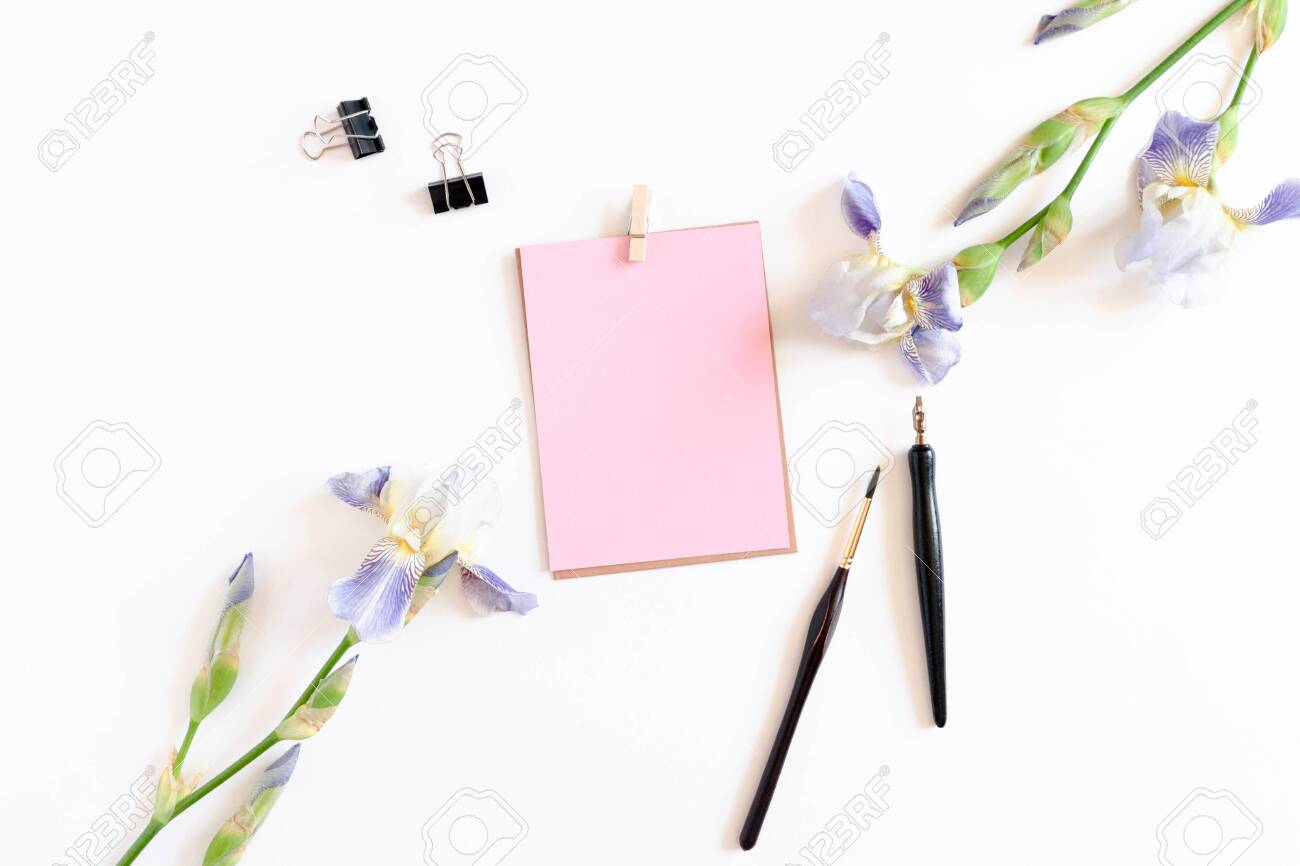 pink pastel paper mockup iris flowers and paint brushes on a paper iris flower