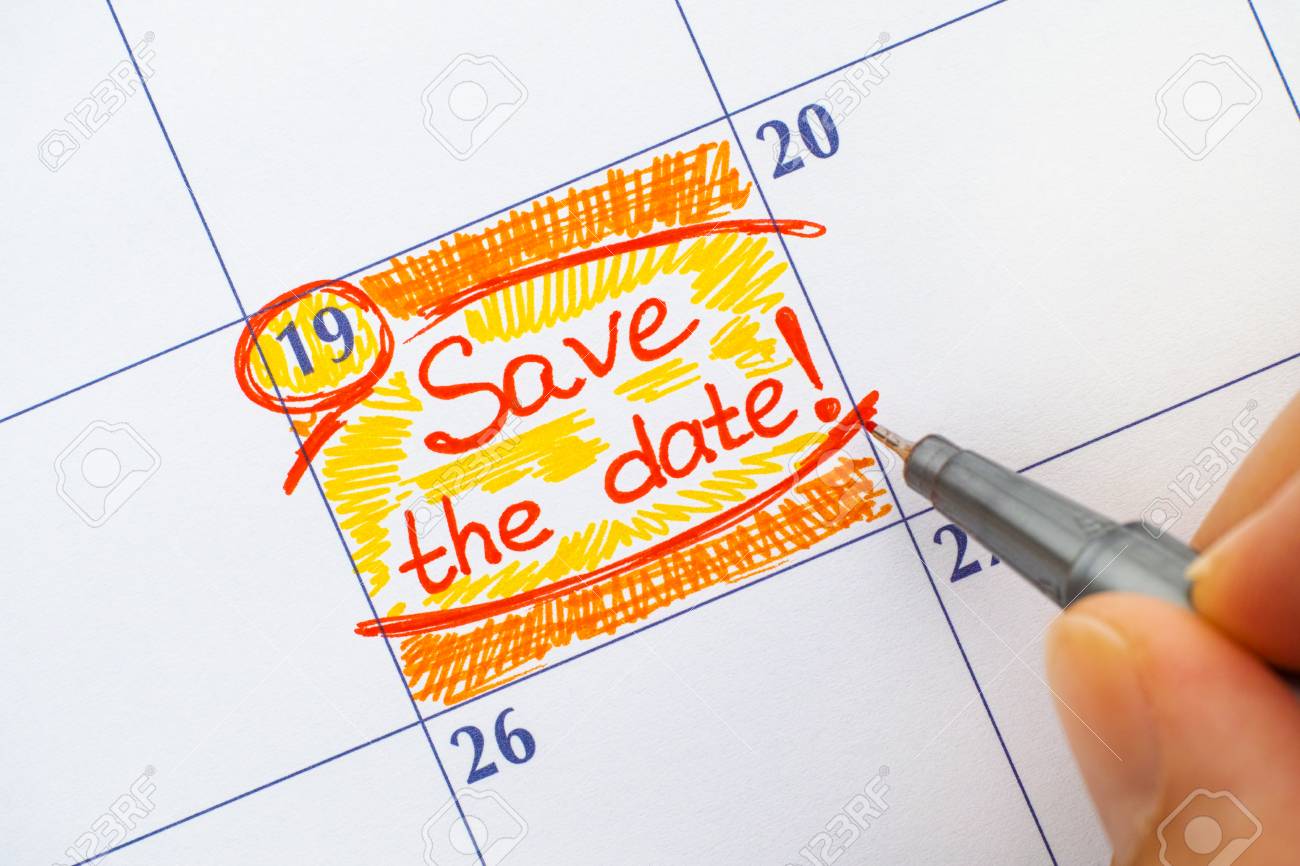 woman fingers with red pen writting reminder save the date stock