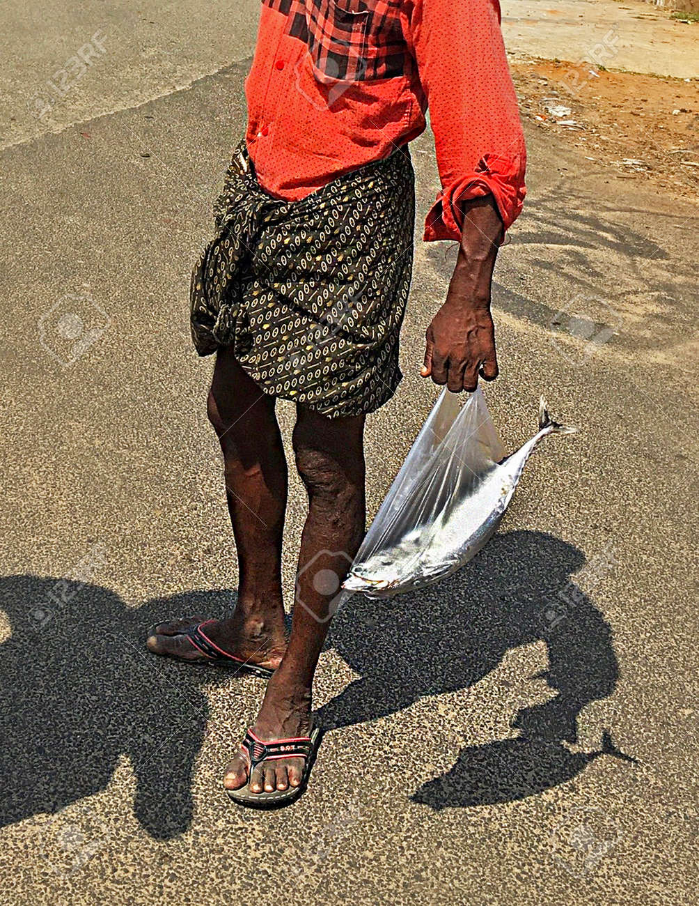 Indian Fisherman With Fish In Plastic Ball Stock Photo Picture