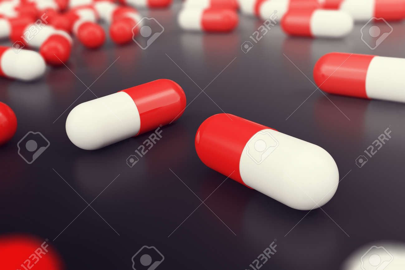 heap of red white round capsule pills with medicine antibiotic