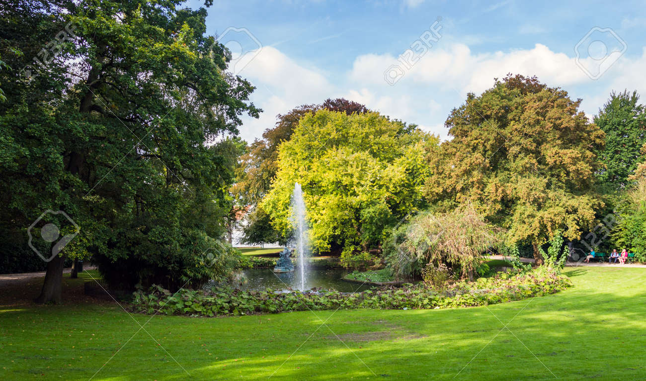 fountain in green queen astrid park in brugge belgium autumn