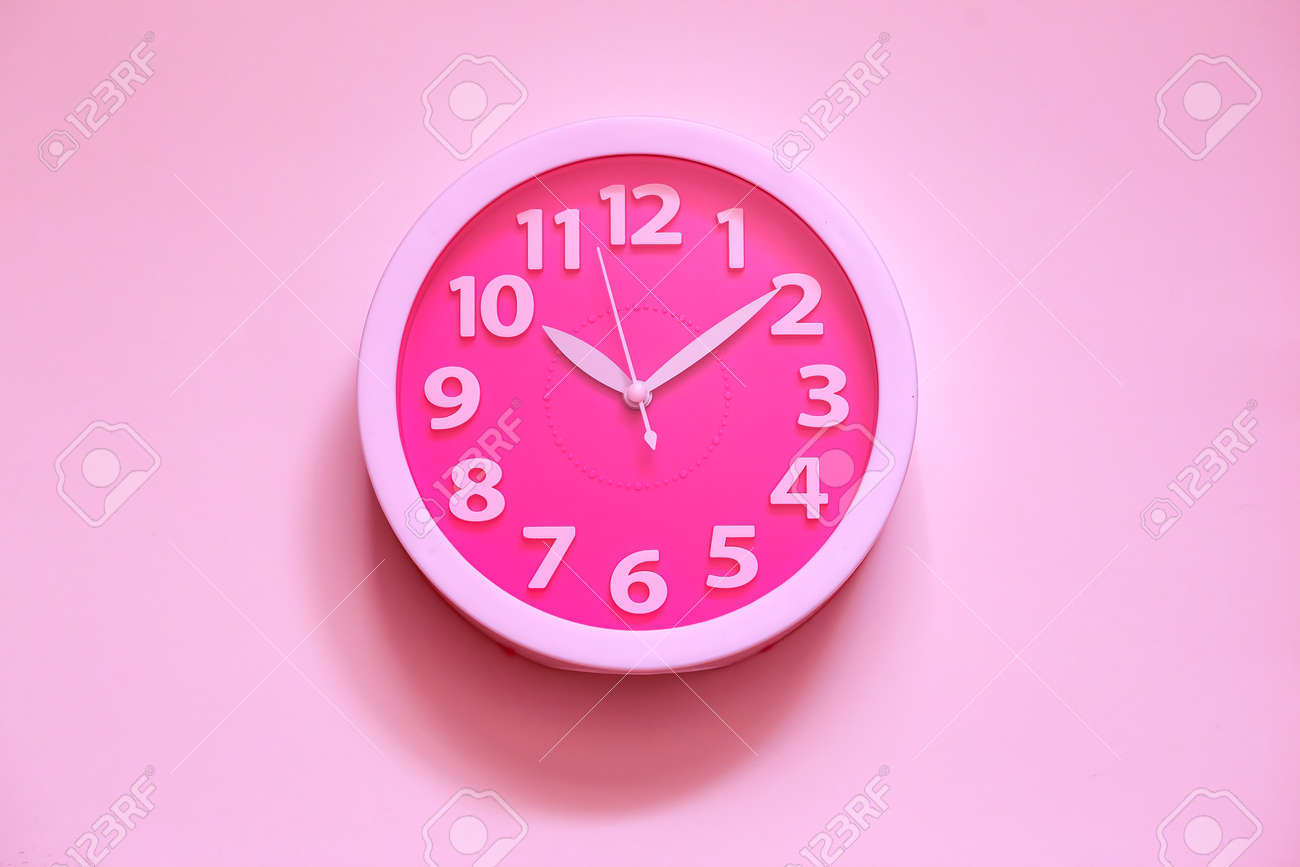 Pink clock on pink painted wall. Minimal time concept. Chrismas eve or new year idea. Stylish analog clock hanging on wall, space for text - 167623203 Pink clock on pink painted wall. Minimal time concept. Chrismas eve or new year idea. Stylish analog clock hanging on wall, space for text - 167623203