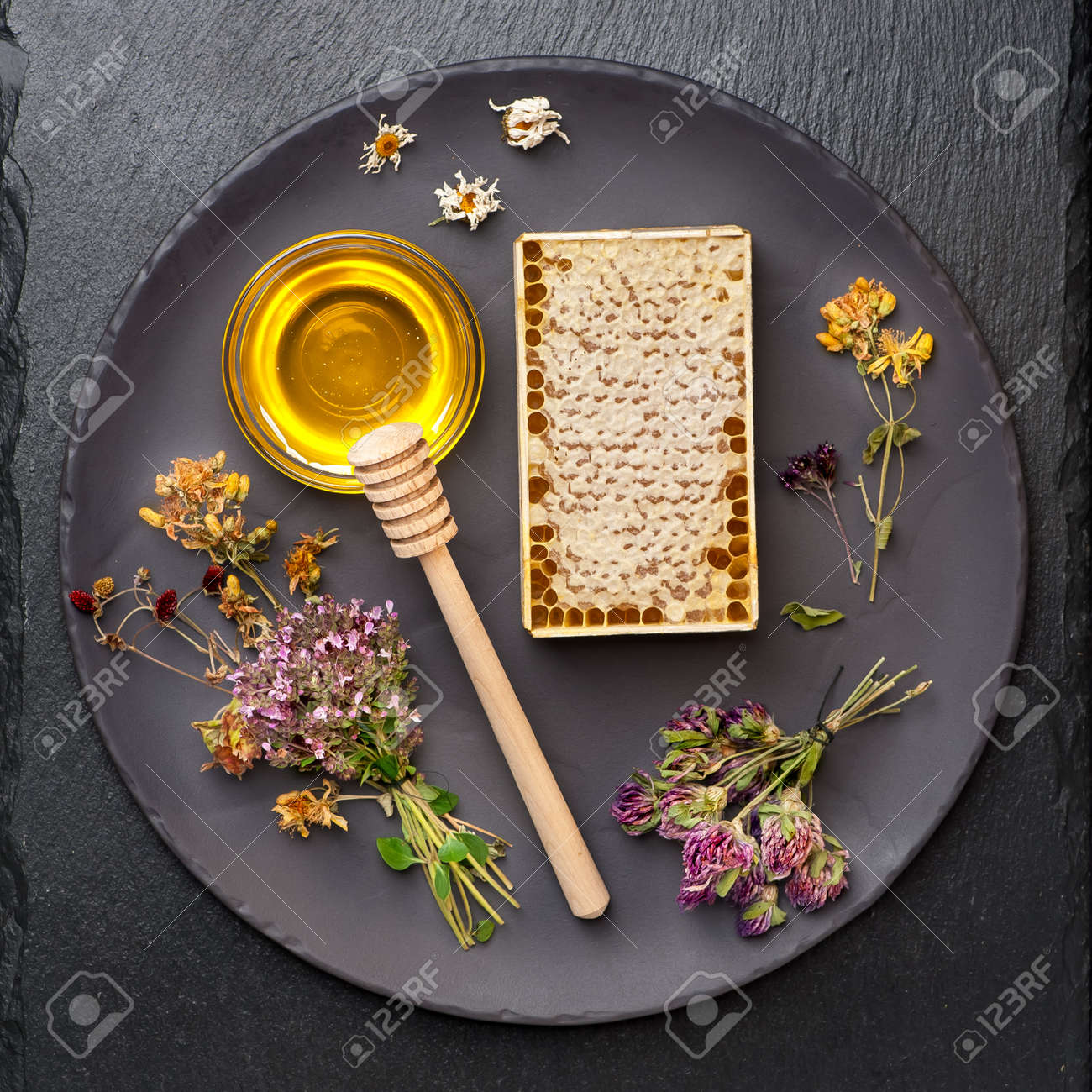 Honey, honeycomb and dried herbs on dark background - 32489614 Honey, honeycomb and dried herbs on dark background - 32489614