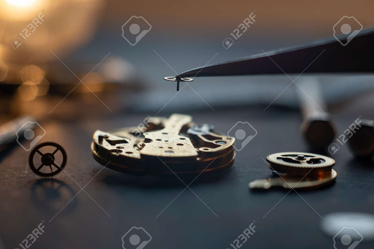 Mechanical watch assembly, watchmakers workshop with many parts and gears - 158412656 Mechanical watch assembly, watchmakers workshop with many parts and gears - 158412656