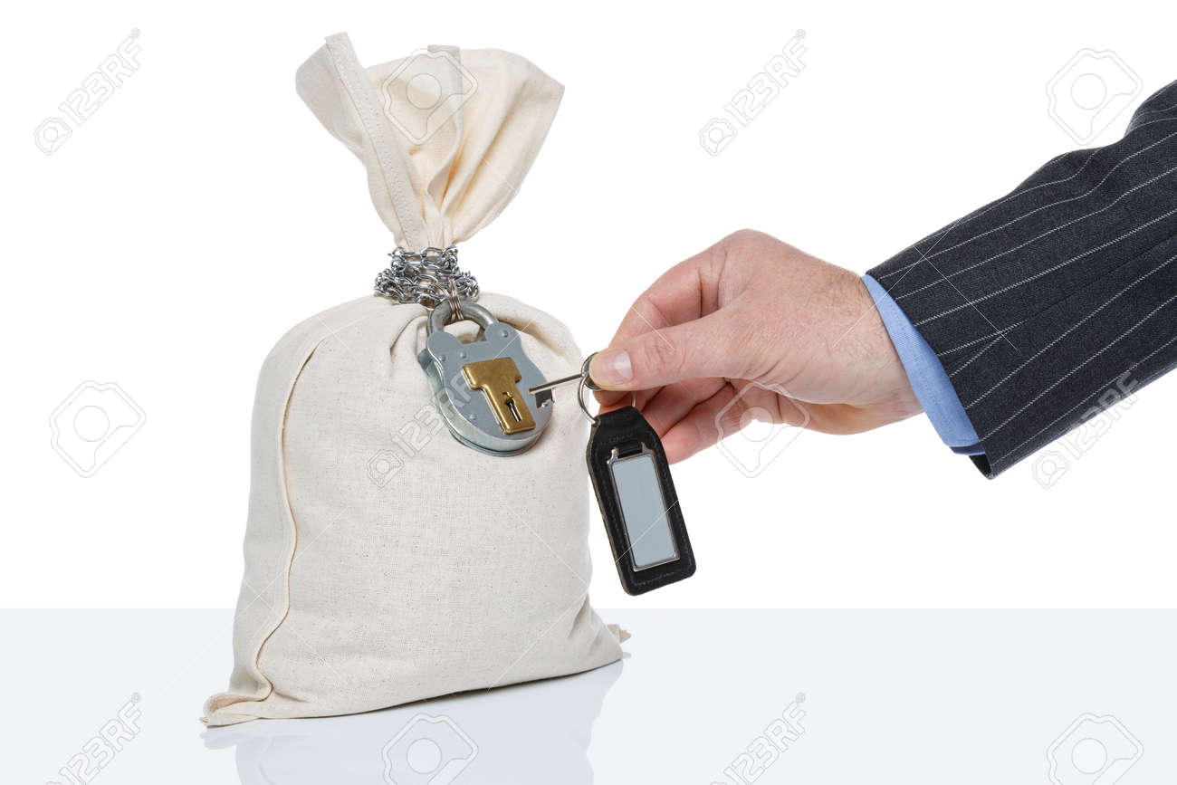 Businessman unlocking a money sack, white background, blank tag on key fob. - 43417170 Businessman unlocking a money sack, white background, blank tag on key fob. - 43417170