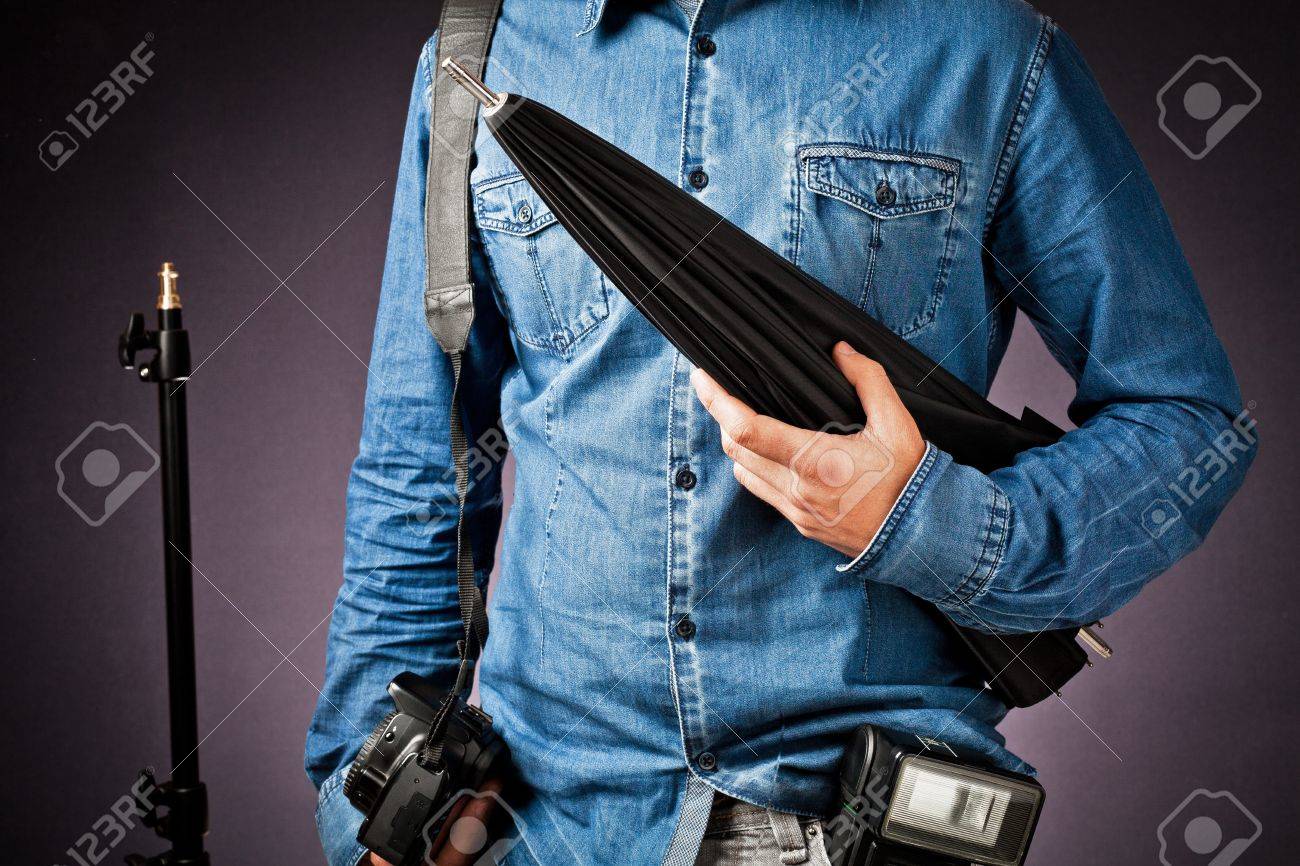 work of photographer and assistant with various accessories: flash, umbrella, stand and camera - 12962855 work of photographer and assistant with various accessories: flash, umbrella, stand and camera - 12962855