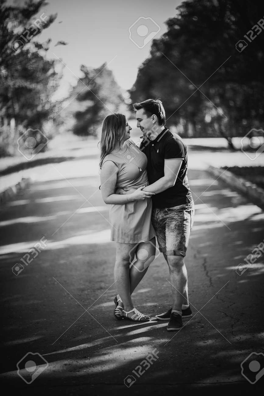 Black white photography romantic young couple laugh on background